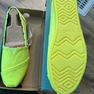 Neon yellow TOMS slip on size 40 European or 9 women